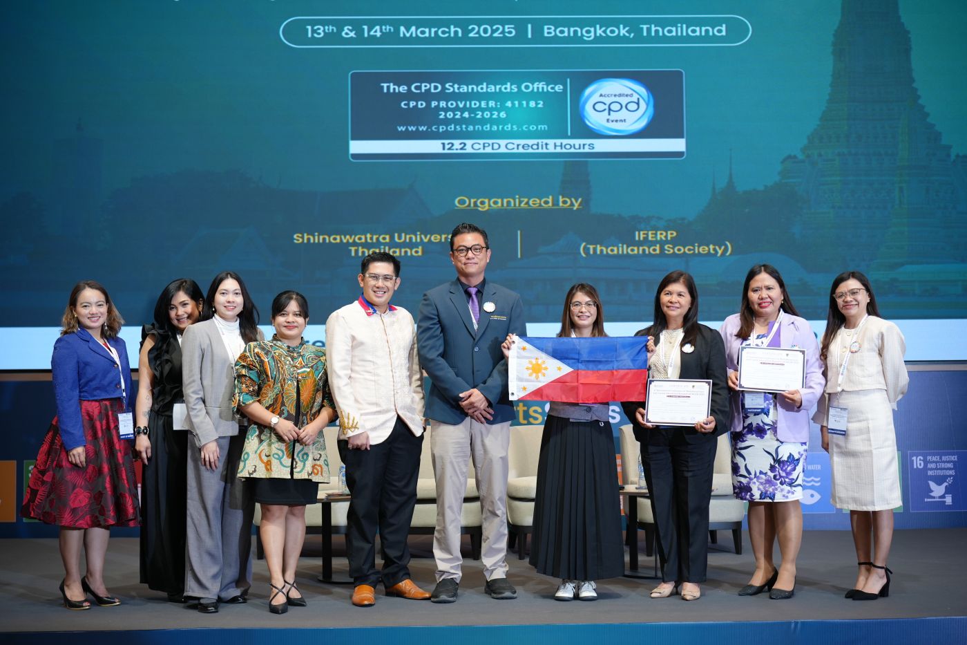 Delegates receiving certificates on stage at a Bangkok conference, March 2025